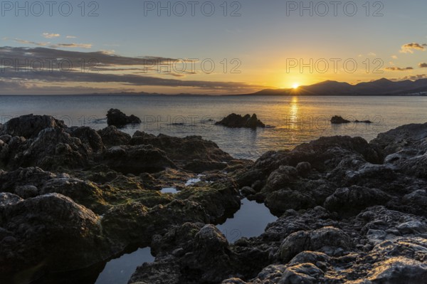 Rocky coast at sunset with calm sea, Canary Islands, Lanzarote, Spain, Europe