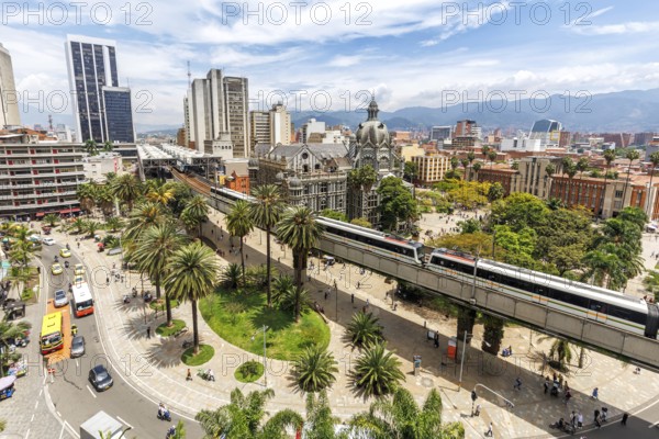 Medellin skyline with a train of the Metro de Medellín at Plaza Botero in Medellin, Colombia, South America