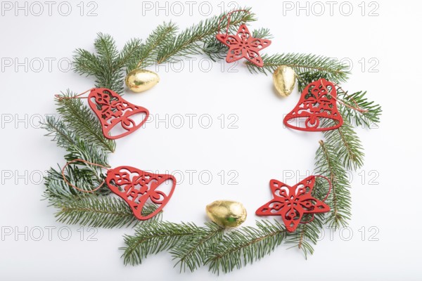 Christmas or New Year wreath composition. Decorations, stars, bells, fir and spruce branches, on white background. Side view, copy space