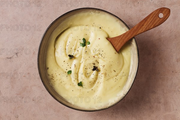 Mashed potatoes, with micro greenery and spices, homemade, on a beige table, no people, top view