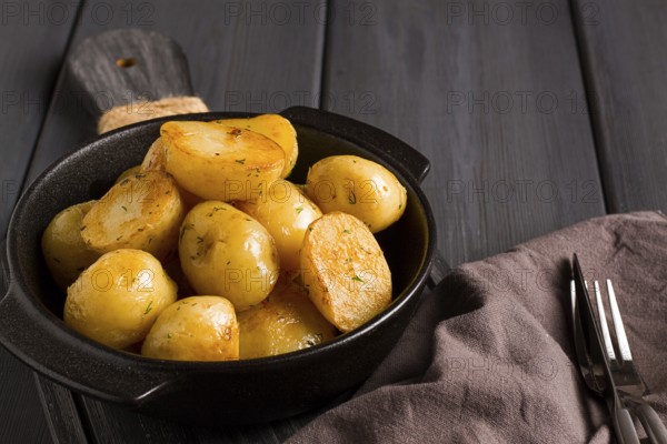 Fresh Cooked, new potatoes, with dill, on a wooden table, selective focus. close-up, toning, no people