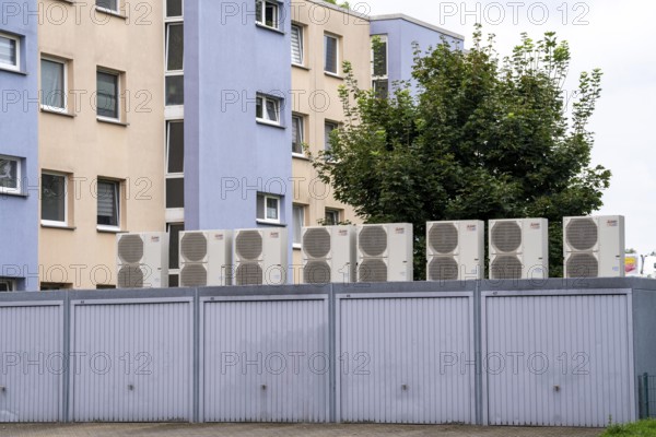 Heat pumps in a residential area, multi-family houses are supplied with heating, cooling and domestic hot water via these devices, installed on garage roofs, modernisation of the flats, Duisburg, North Rhine-Westphalia, Germany, Europe