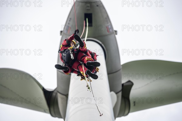 Height rescuers from the Gelsenkirchen fire brigade practise abseiling from a wind turbine from a height of 110 metres after rescuing an accident victim from the nacelle, Gladbeck, North Rhine-Westphalia, Germany, Europe