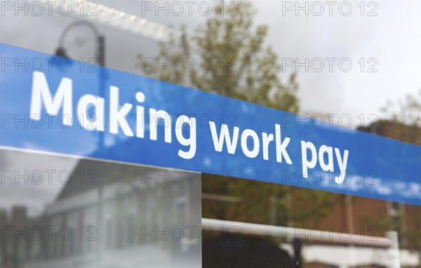 Making Work Pay banner in window of Jobcentre Plus office, Department for Work and Pensions, Devizes, Wiltshire, England, UK