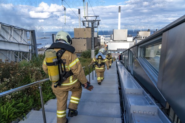 CopenHill, waste incineration plant and artificial ski slope, firefighters under respiratory protection, endurance training, skiing with a view of the ski lift, 90 metres high and 400 metres long slope on artificial turf, Copenhagen, Denmark, Europe