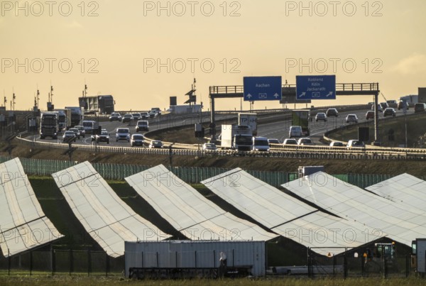 20 MWp ground-mounted photovoltaic system, from RWE, with over 36600 solar modules, in a 200 metre long strip of land, over 1 km long, along the A44 motorway near Bedburg, at the Jackerath junction, recultivated open-cast mine site, North Rhine-Westphalia, Germany, Europe