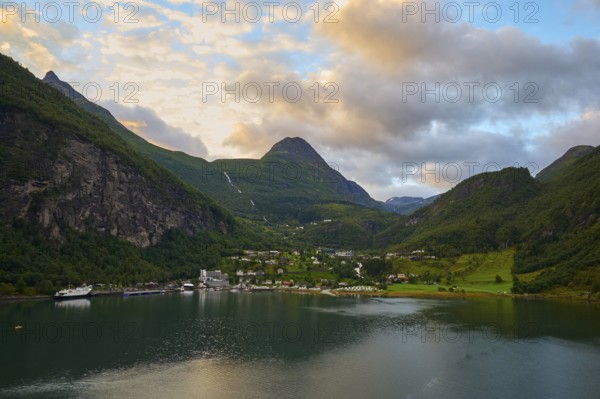 Geiranger with fjord landscape with mountains embedded in nature, covered by dramatic clouds, Geiranger, Geiranger Fjord, Stranda, Romsdal, Norway, Europe