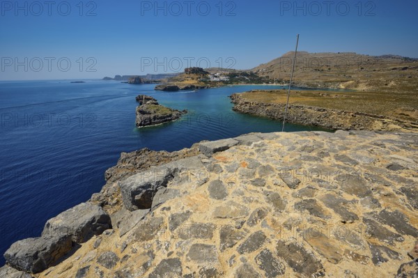 Extensive view of the blue sea and the rocky coast on a clear day, tomb of Cleovoulos the Lindier, ruins, near Lindos, Lindos, Rhodes, Dodecanese, Greek Islands, Greece, Europe