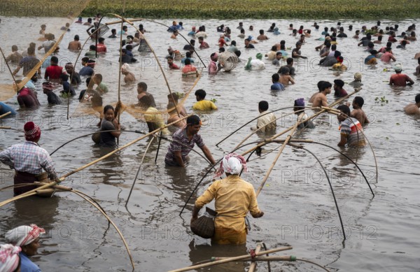 Villagers participate in a community fishing event on the occasion of the Bhogali Bihu festival at Panbari village in Assam on 13 January 2025. Magh Bihu, also known as Bhogali Bihu, is one of the most vibrant festivals celebrated in Assam and other parts of Northeast India