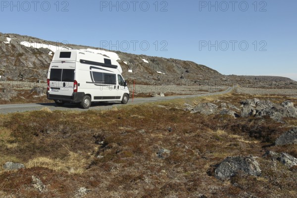 Campervan/caravan on a lonely coastal road through the tundra near Hamningberg on the Barents Sea, Lapland, Northern Norway, Norway, Scandinavia, Europe