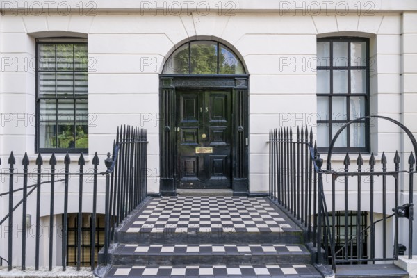 Elegant house entrance with solid black front door and white façade, Holborn, London Borough of Camden, England, United Kingdom, Europe