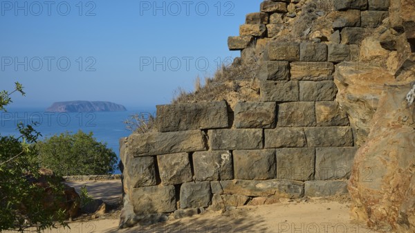 Ancient stone structures against a clear blue sky with the sea in the background, Palaiokastro, Ancient Fortress, 3rd and 4th century BC, above Mandraki, Nisyros, Dodecanese, Greek Islands, Greece, Europe