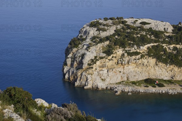 Steep rocky coast with calm, blue water and green vegetation under a clear sky, Anthony Quinn Bay, Vagies Bay, Rhodes, Dodecanese, Greek Islands, Greece, Europe