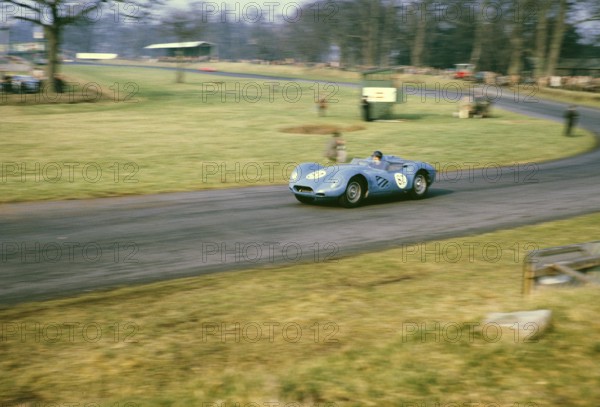 British sports racing driver Bill de Selincourt (1921 2014) at the wheel of a Lister Jaguar Knobbly, BARC race on the Oulton Park race track, Cheshire, England, 17 March 1962