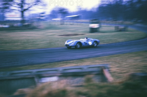 British sports racing driver Bill de Selincourt (1921 2014) at the wheel of a Lister Jaguar Knobbly, BARC race on the Oulton Park race track, Cheshire, England, 17 March 1962