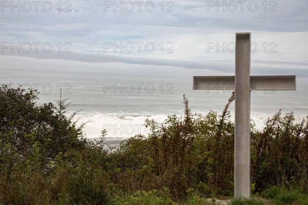 Klamath, California - A cross stands on a hill above the Pacific Ocean near a small cemetery on the Yurok Reservation