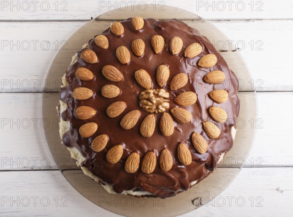 Homemade chocolate cake with almonds on white wooden background. top view, flat lay