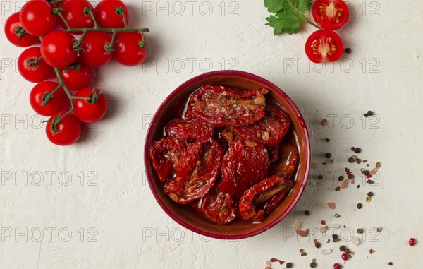 Dried tomatoes, in a bowl, top view, on a white background