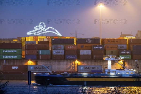 Container Handling Centre, Gateway West Terminal, Logport 2, cargo ship, in Duisburg on the Rhine, in the background Tiger and Turtle - Magic Mountain is a landmark modelled on a roller coaster on Heinrich-Hildebrand-Höhe in Angerpark in Duisburg-Angerhausen, North Rhine-Westphalia, Germany, Europe