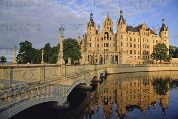 Europe, Germany, Mecklenburg-Western Pomerania, Schwerin, Schwerin Castle, built 1845 to 1857 in the style of romantic historicism, today seat of the state parliament, front with bridge to the castle island, evening light, Schwerin, Mecklenburg-Western Pomerania, Germany, Europe