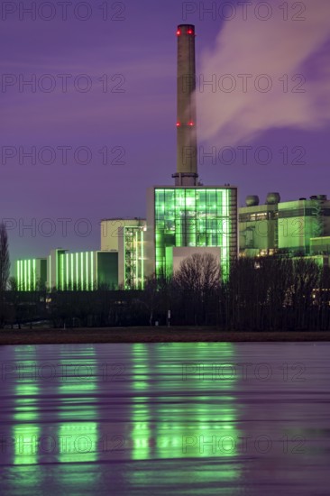 The Lausward combined heat and power plant in Düsseldorf, gas and steam turbine power plant, operated by Stadtwerke Düsseldorf and EnBW, on the Rhine, green illuminated city window, the chimney of the Fortuna power plant unit, the power plant generates electricity, also traction current and district heating, North Rhine-Westphalia, Germany, Europe