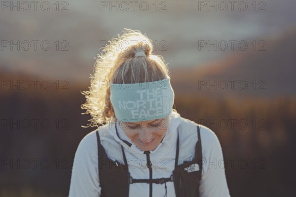 Trail running in autumn on the Jochberg on Lake Walchensee against the wonderful backdrop of the Alps, Bavaria, Germany, Europe