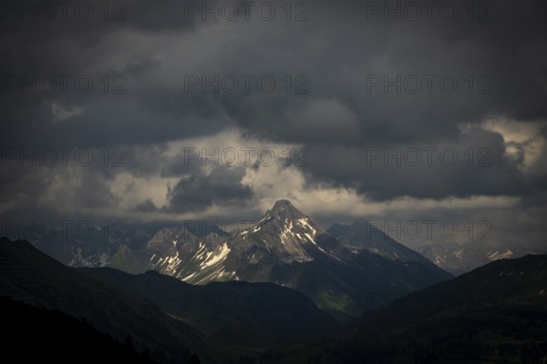 Summit of the Biberkopf with remnants of snow and dramatic clouds, Lech, Lechquellengebirge, Vorarlberg, Austria, Europe