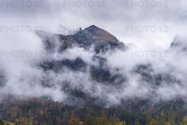 View of part of the Tennengebirge from Oberscheffau. The mountains are covered in clouds. Autumn. Salzburger Land, Upper Austria, Austria, Europe