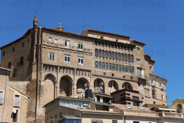 Large historic stone building with several windows and balconies under a clear blue sky, episcopal palace, Palacio Episcopal, Tarazona, Zaragoza, Aragon, Spain, Europe