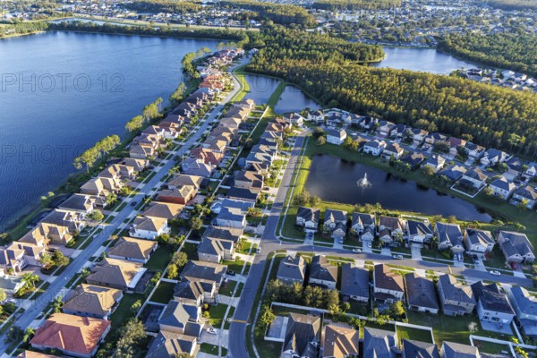 Aerial view of a new housing estate with houses on the lake in Wyndham Lakes, Orlando, USA, North America