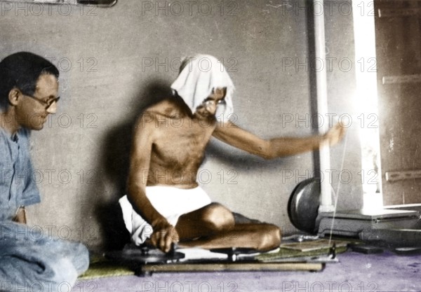 Bharat Anand observing Mahatma Gandhi spinning, Wardha, Maharashtra, India, Asia, 1937, Asia