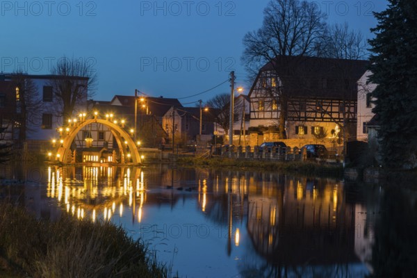 Floating candle arch in the village pond of Bärnsdorf near Moritzburg. The arch is 4.5m high, almost 8m wide and was built by local craftsmen as a special decoration for the local Christmas market