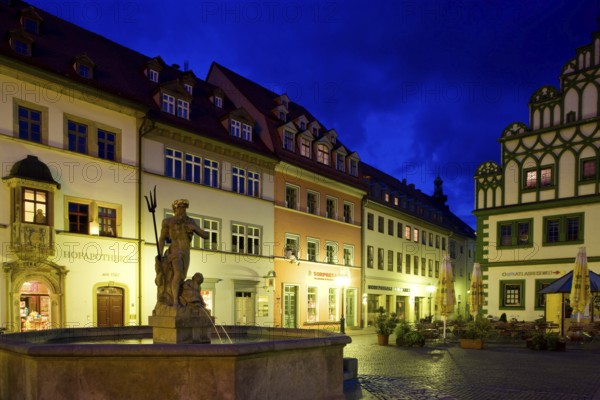 The square was given its distinctive shape in the 16th century by the town house and the semi-detached house to the east, the left half of which is now known as the Cranach House, the Court Pharmacy to the north and the inn Zum Schwarzen Bären to the south.In the centre of the market, the Neptune Fountain