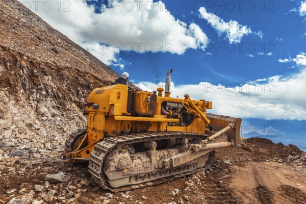 LADAKH, INDIA, SEPTEMBER 12, 2011: Bulldozer doing road constractuion on Kardung La pass in Himalayas. Ladakh, Jammu and Kashmir, India, Asia