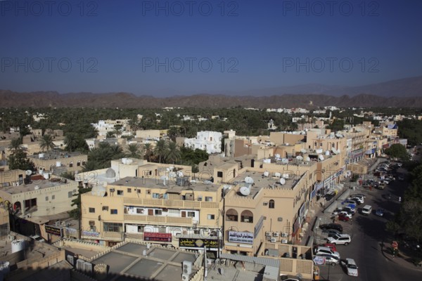 View of the city and the palm gardens of Nizwa from the fort. Nizwa is the centre of the Omani heartland. The oasis town lies on the southern edge of the Hajar Mountains near the Jabal al-Achdar, the highest mountain range in Oman