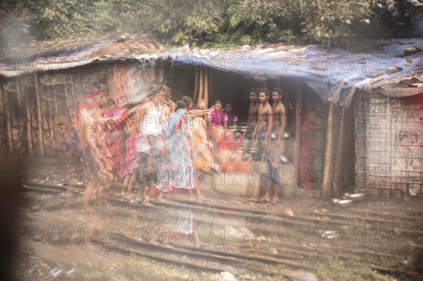 Family in front of their dwelling in the reflection of a broken mirror, Tejgaon Slum Area, Dhaka, Bangladesh, Asia