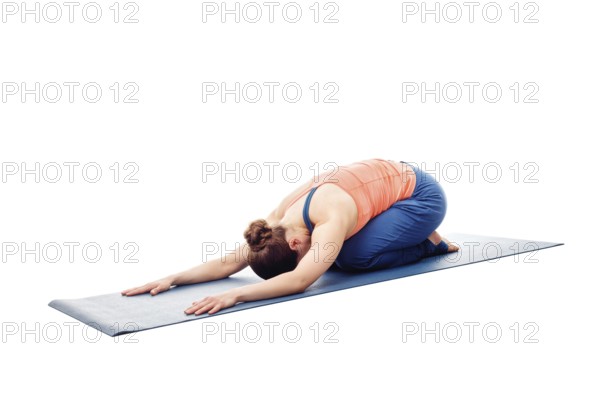 Woman doing Ashtanga Vinyasa Yoga relaxation asana Balasana, child posture, resting pose or counter asana for many asanas isolated on white background