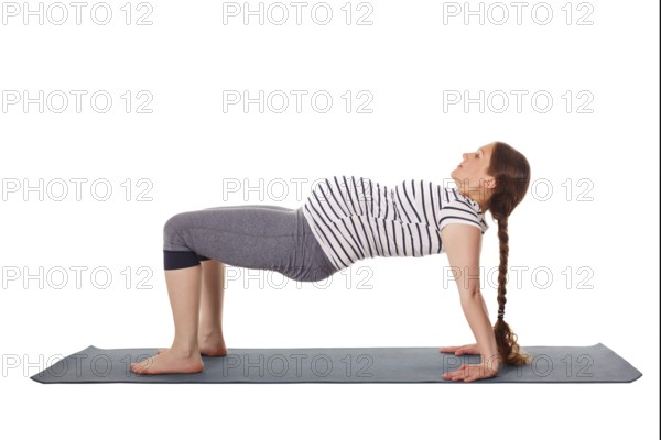 Pregnancy yoga exercise, pregnant woman doing yoga asana Purvottanasana Upward Plank Pose isolated on white background