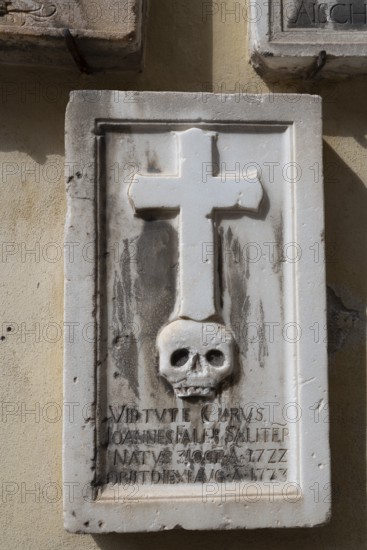 Gravestone with cross and skull, spa town of Merano, South Tyrol, Italy, Europe