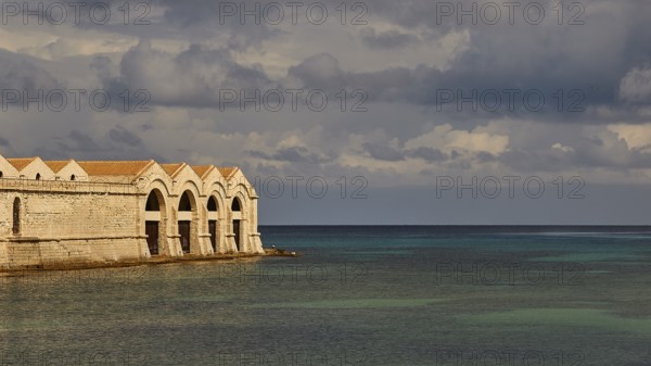 Green sea, Dark clouds, Dramatic light, Tonnara, Old tuna factory, Favignana town, Main town, Favignana, Egadi Islands, Sicily, Italy, Europe