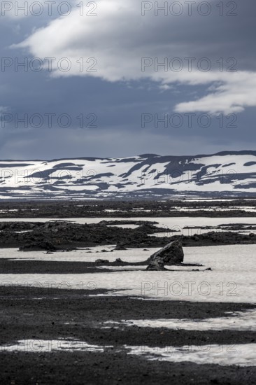 Snow-covered volcanic landscape with volcanic sand and petrified lava, crater of Askja volcano, Icelandic highlands, Iceland, Europe