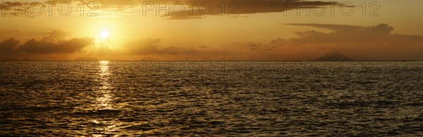 Sunset panorama on the beach of Tropea with the Aeolian (Liparic) Islands and the volcanic island of Stromboli on the horizon, Tropea, Vibo Valentia, Calabria, Southern Italy, Italy, Europe