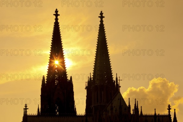 The sun shines through one of the two towers of Cologne Cathedral, Cologne, Rhineland, North Rhine-Westphalia, Germany, Europe