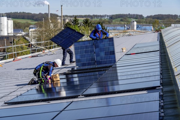 Installation of solar modules on the roof of a commercial enterprise, over 400 photovoltaic modules are installed on the roof, North Rhine-Westphalia, Germany, Europe