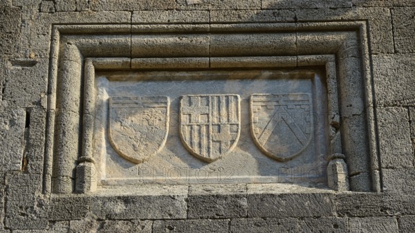 Stone relief with three coats of arms, moving in a rectangular frame on a historic wall, Knights' Street, Rhodes Old Town, Rhodes Town, Rhodes, Dodecanese, Greek Islands, Greece, Europe