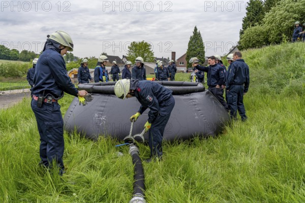 Forest fire-fighting exercise by the Essen fire brigade, the water supply was rehearsed over longer distances to the scene, water basins were set up there from which a fire-fighting helicopter can take water, 10 cubic metres capacity, North Rhine-Westphalia, Germany, Europe