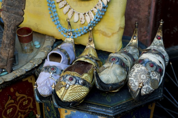 Traditional decorated babouche shoes in the medina, shop, bazaar, flea market, souk, trade, display, symbol, tradition, clothing, shopping, shopping, souvenir, slippers, Marrakech, Morocco, Africa