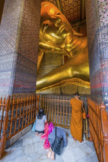 Reclining Buddha with praying monk in Wat Pho temple, Buddhism, religion, world religion, sculpture, sculpture, art, statue, culture, believer, faith, peace, Asian, travel, holiday, tourism, representation, palace, tradition, traditional, decoration, decorated, house of prayer, building, attraction, landmark, gilded, gold, holy, pray, meditation, monastery, spirituality, meditate, spiritual, monument, famous, sight, philosophy, architecture, capital, Bangkok, Thailand, Asia