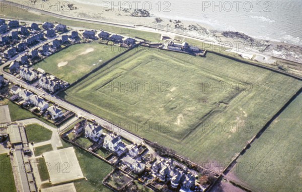 Series of oblique aerial photographs of Roman sites associated with Hadrian's Wall, c. 1970s Earthworks of the Roman coastal fort of Alavna, Maryport, Cumbria, England, UK from a north-easterly direction