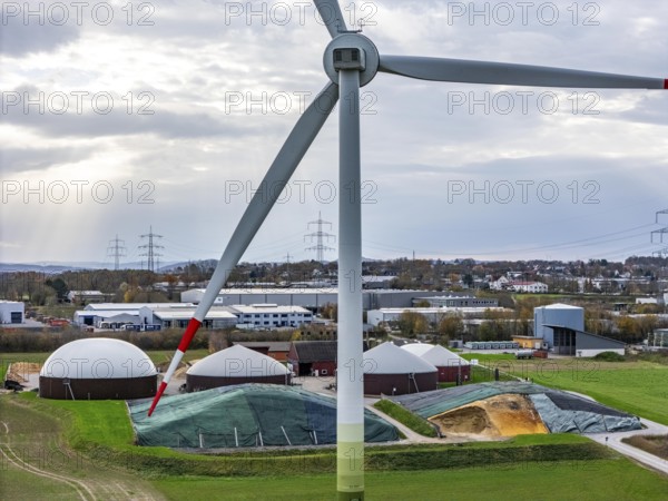 Biogas plant produces gas from various biomass, electricity is generated in combined heat and power plants with the biogas produced and sold to companies in the neighbouring industrial estate, the heat generated is fed into a local heating network, gas storage and wind power plant, Ense, North Rhine-Westphalia, Germany, Europe